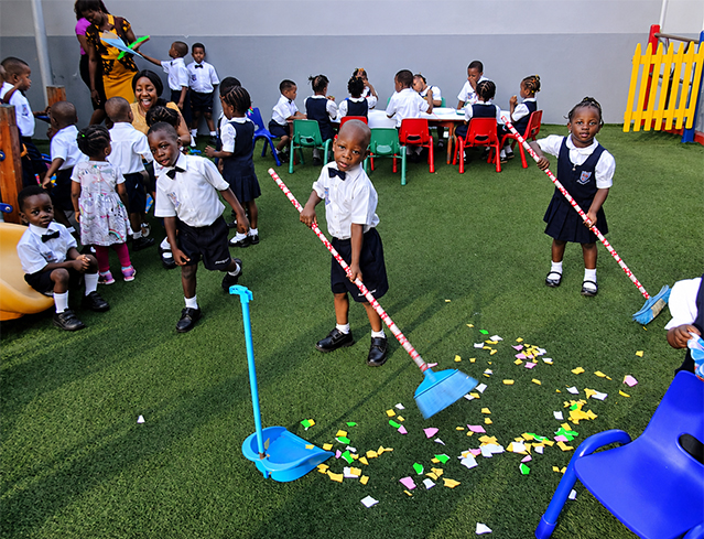 Children Sweeping at Daycare Playground sm